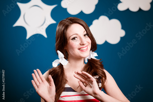 Fotografia, Obraz Amazed young woman actress over theatrical play handmade blue sky background