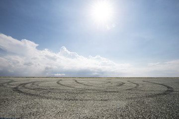 empty asphalt road in blue sunny sky