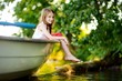 © MNStudio - Cute little girl having fun in a boat by a river