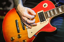 Musician Blurred Hands On Orange Guitar String Guitar Closeup