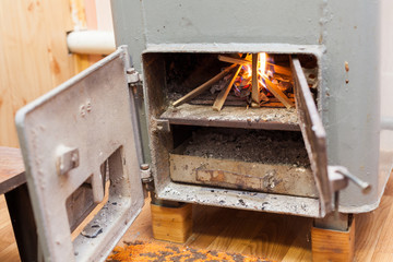 Wood burning inside the Solid bio fuel boiler. Renewable source of energy. green environmentally friendly fuel. Old warm cozy burning fire in a fireplace close up