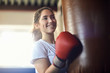 © Connect Images - Young female boxer punching punch bag in gym