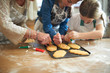 © Connect Images - Cropped shot of senior woman and granddaughters decorating Christmas tree cookies