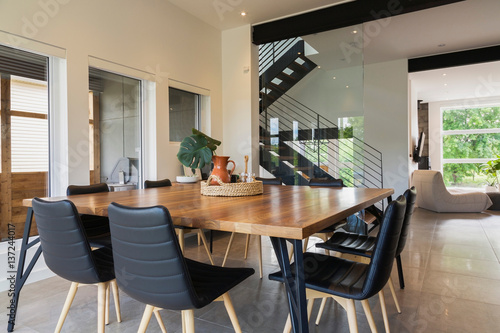 American Walnut Wood Dining Table And Black Leather Sitting Chairs With Ash Legs In The American Walnut Wood Dining Table And Black Leather Sitting Chairs With Ash Legs In The