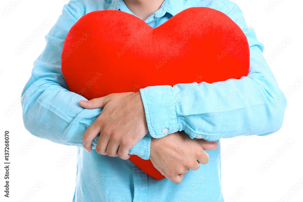 Man holding red heart on white background, closeup