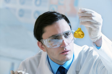 Wall Mural - Young male scientist making experiments in laboratory