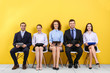 © Africa Studio - Group of people waiting for job interview on yellow wall background