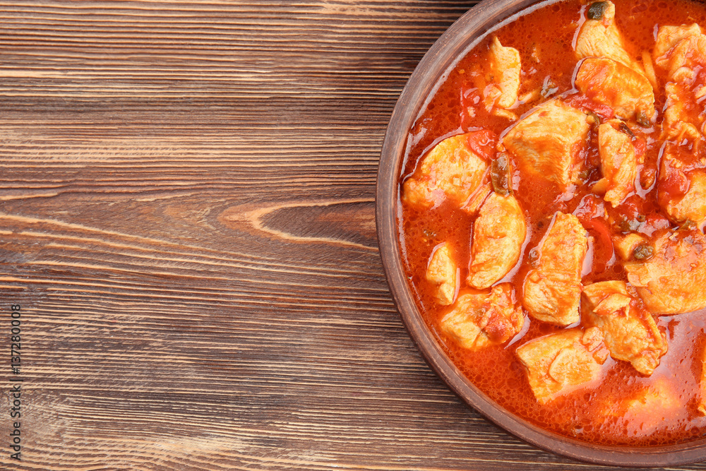 Chicken tikka masala in wooden bowl, closeup