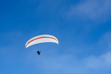 Paragliding in Ukraine over the against clear blue sky