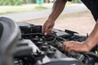 © Johnstocker - Man with checking car engine.