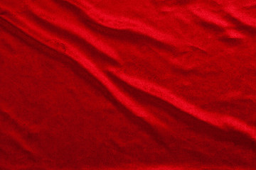 Flowing red luxury shiny fabric textile material for texture background