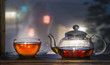 Black tea on the window sill. Hot tea. Black Tea leaves at the bottom of the cup. Tea time. Winter.