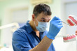 © yana_vinnikova - Young man dentist in protection gloves and a mask