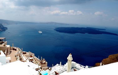 Wall Mural - Cloud spring day on vacation. The Island Of Santorini, Greece. Typical architecture in white and blue tones. Filmed in the journey to the Cycladic Archipelago and the Mediterranean