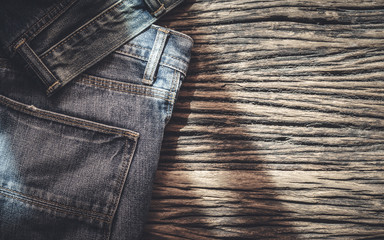 Blue jeans on wooden background, Top view with copy space