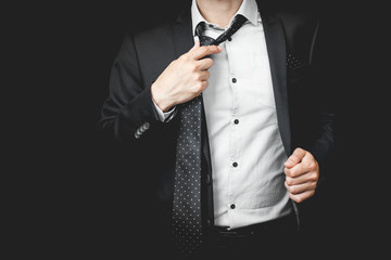 Wall Mural - man in suit on a black background