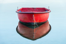 Red Wooden Fishing Boat On A Background Of Water