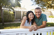 © Monkey Business - Portrait Of Mature Couple Looking Over Back Yard Fence