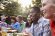 © Monkey Business - Group Of Mature Friends Enjoying Outdoor Meal In Backyard