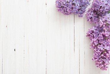 Wall Mural - The beautiful lilac on a wooden background