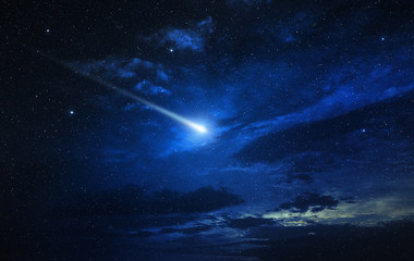 Canvas Print - twinkling comet in a blue starry sky