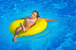© SuperCoolPhotography - Real toddler girl relaxing at swimming pool