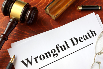 Document with title Wrongful Death o a wooden surface.