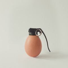 Egg grenade bomb on bright white background. Minimal food concept.