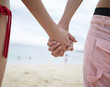 © mnimage - Couple holding hands at beach