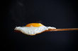 Fried egg with a wooden spoon