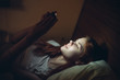 © SHOTPRIME STUDIO - woman lies in bed and looks into phone