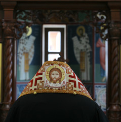 orthodox bishop praying in front of altar