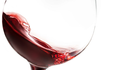 wave of red wine in a glass isolated on white background