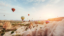 Hot Air Balloon Flying Over Rock Landscape At Cappadocia Turkey.