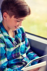 Sticker - happy boy with tablet pc in travel bus or train