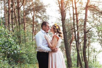 Wall Mural - Happy couple in a pine forest Beauty world