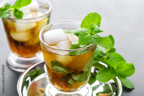 Valokuva Mint Julep cocktail with bourbon, ice and mint in glass on black background