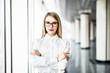 © F8  \ Suport Ukraine - Portrait of blonde business woman with crossed hands in modern office.