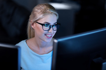 Smiling female programmer decoding codes at work