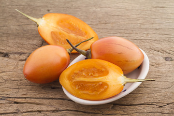 Wall Mural - Tamarillo fruit (disambiguation) from South America, on wooden background