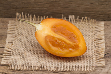 Wall Mural - Tamarillo fruit (disambiguation) from South America, on wooden background