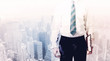 © ra2 studio - Business man standing on roof with city in the background