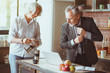 © zinkevych - Positive aged couple standing in the kitchen