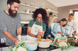 © Flamingo Images - Group of friends cheerfully cooking