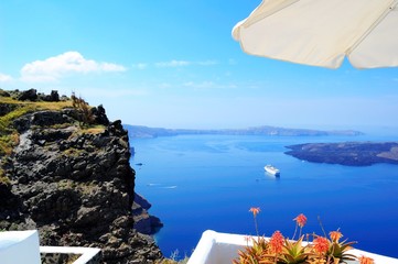 Wall Mural - Piece of Mediterranean cruise On Santorini island, Greece. The view from the hotel on the lower terrace and the shore of the Aegean sea. characteristic architecture blue and white tones in the decor