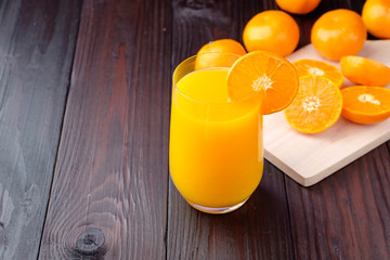 Orange juice on wooden background