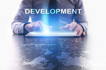 businessman is using tablet pc and selecting development.