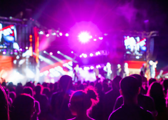 Blurred Youth Music Festival of pop music. Laser show on the stage. The crowd of fans. Bright abstract background ideal for any design. Blurred bokeh basic background for design 
