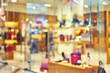 © marina_larina - Blurred background of a modern shopping mall. Big sales on Black Friday for Christmas. Showcases fashion boutique with luxury shoes. Bokeh basic background for design