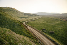 View Of Dirt Road Passing By Mountain